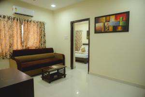 a living room with a couch and a mirror at StayGuru Park View Residency in Bhuj