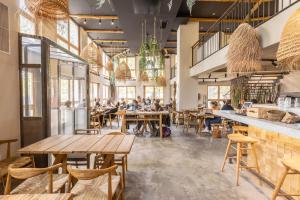 a group of people sitting at tables in a restaurant at Babel Community Hôtel - Montpellier centre in Montpellier