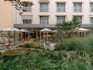 a hotel with tables and chairs and a building at Hotel Josef in Prague