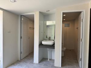 a bathroom with a sink and a toilet at Lazy Garden Hostel in Phra Ae beach +22 photos