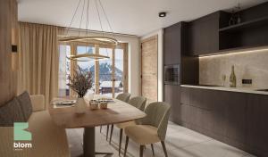 een keuken en eetkamer met een tafel en stoelen bij Kitzhorn Suites in Sankt Johann in Tirol