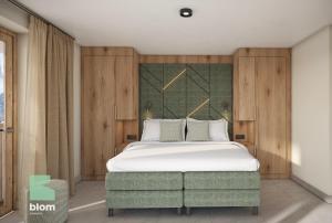 een slaapkamer met een groot wit bed en houten wanden bij Kitzhorn Suites in Sankt Johann in Tirol
