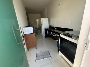 a kitchen with a stove and a refrigerator at Casa Terra in Prado