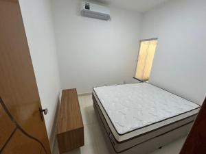 a small white room with a bed in it at Casa Terra in Prado +9 photos