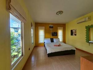 a bedroom with a bed and a large window at Sam roi yot Sea sight Resort in Sam Roi Yot +44 photos