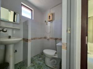 a bathroom with a toilet and a sink at Sam roi yot Sea sight Resort in Sam Roi Yot