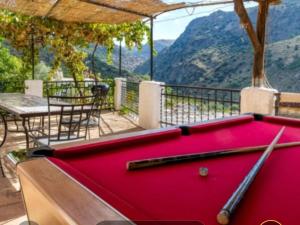 a pool table on a balcony with a view of a mountain at Casa Natalia in Mecina Fondales