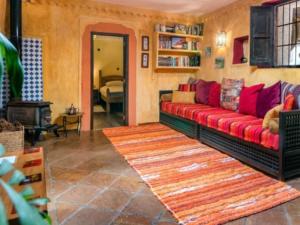 a living room with a red couch and a fireplace at Casa Natalia in Mecina Fondales