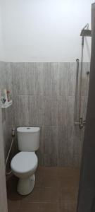 a bathroom with a toilet and a shower at Dhika Adventure DPS in Denpasar +20 photos
