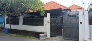 a white fence with a gate in front of a house at Dhika Adventure DPS in Denpasar