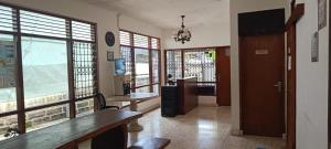 a room with a table and some windows at Dhika Adventure DPS in Denpasar