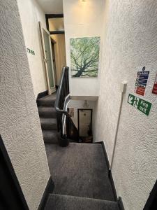 a staircase in a building with a sign on the wall at Glen Allan Hotel in Blackpool