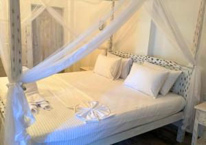 a bedroom with a bed with a canopy at South Roots in Unawatuna