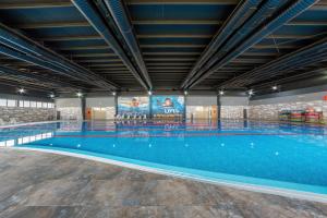 a large swimming pool in a building at Grand Hotel Kapan, Armenia in Kapan