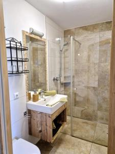 a bathroom with a sink and a shower at Seyerlehnerhof in Maria Neustift +51 photos