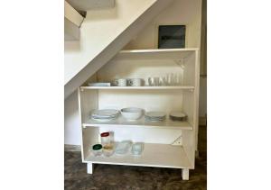 a shelf under the stairs with dishes on it at South Roots in Unawatuna +17 photos