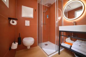 a bathroom with a shower and a toilet and a sink at Résidence Kaliopé in Le Lavandou