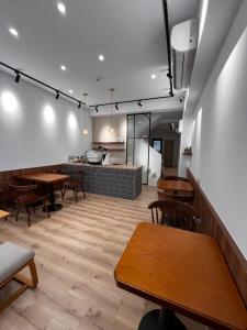 a restaurant with wooden tables and chairs and a counter at Zao Orange Homestay in Taitung City