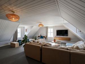 a living room with two couches and a tv at Salt & Butter in Hermanus