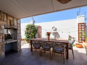 a table and chairs on a patio with a fireplace at Salt & Butter in Hermanus