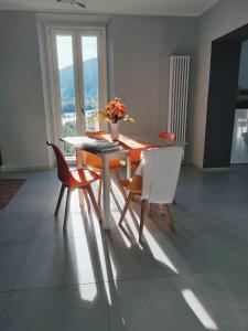 a dining room with a table and some chairs at Casa Sole in Cannobio