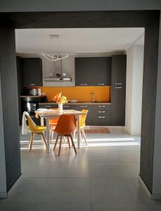 a kitchen with a dining table and yellow chairs at Casa Sole in Cannobio