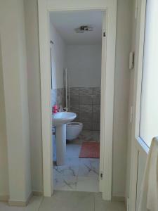 a bathroom with a sink and a toilet at Casa Sole in Cannobio +1 photo