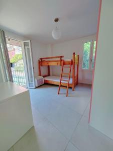 a room with a bunk bed and a ladder at Casa Sole in Cannobio