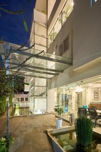 a large white house with a pool in a yard at Urban Opulence in Bangalore