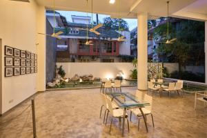 a dining room with tables and chairs and a fireplace at Urban Opulence in Bangalore