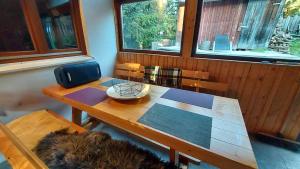 a wooden table in a room with a table and a chair at Bori Guest House in Miercurea-Ciuc +29 photos