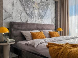 a bed with two pillows and a phone in a room at Qoople Elite Admiral Apartment in Alanya +38 photos