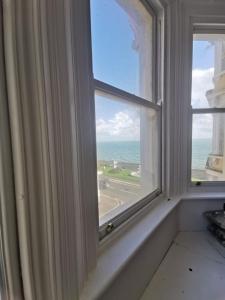 an open window with a view of the ocean at Victoria Guest Apartment in Ramsgate