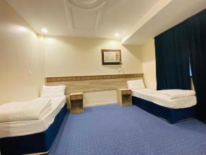 a hospital room with two beds and a window at Emaar million6 in Quai