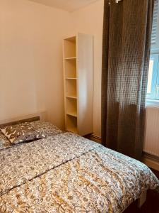 a bedroom with a bed and a book shelf at Le beffroi in Abbeville