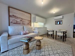 a living room with a couch and a table at Adonis Collection La Baule in La Baule