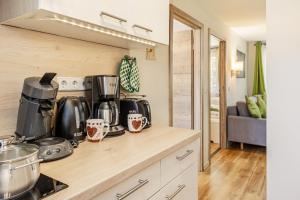 a kitchen with a counter top with pots and pans at Ferienhaus Biber im Sternenpark in Lochow