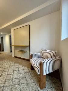 a living room with a couch and a mirror at Adonis Collection La Baule in La Baule