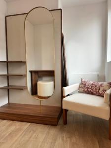 a mirror and a chair in a room at Adonis Collection La Baule in La Baule