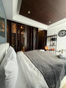a bedroom with a large bed with a clock on the wall at New Gudauri Atrium in Gudauri