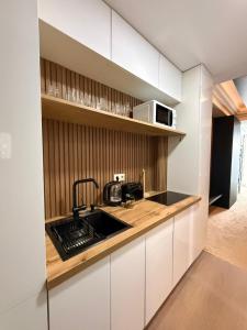 a kitchen with a sink and a microwave at New Gudauri Atrium in Gudauri