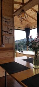 a vase of flowers on a table in a room at Cabanas do Arvoredo in São José do Cerrito +1 photo