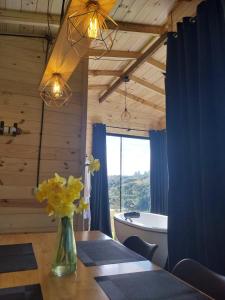 a dining room with a table and a bath tub at Cabanas do Arvoredo in São José do Cerrito