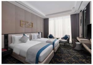 a hotel room with two beds and a television at Vittori Garden in Riyadh +26 photos