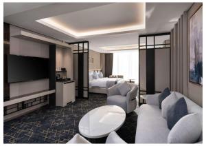 a hotel room with a bed and a television at Vittori Garden in Riyadh