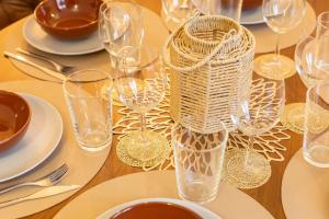 a table with wine glasses and plates on it at Altstadt Loft XL I 90 qm I 2 Schlafzimmer I 2 Arbeitsplätze I 6 Gäste in Passau