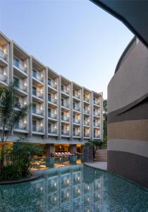 an external view of a building with a swimming pool at Radisson Blu Hotel & Residence Nairobi Arboretum in Nairobi