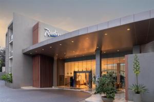 a building with a sign on the front of it at Radisson Blu Hotel & Residence Nairobi Arboretum in Nairobi