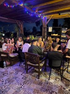 a group of people sitting in chairs at a party at Gold Coast Hostel in Antalya