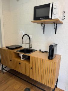 a kitchen with a sink and a microwave on a counter at Cascais Garden House 103 in Cascais +3 photos